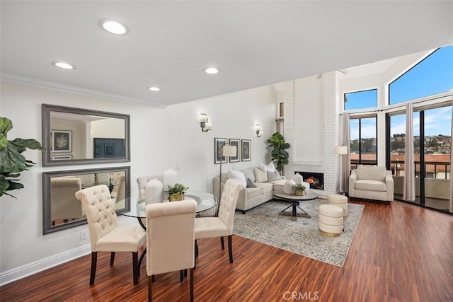 27869 Mazagon Unit 111, Mission Viejo, CA 92692 - dining area featuring a fireplace, wood finished floors, recessed lighting, crown molding, and baseboards