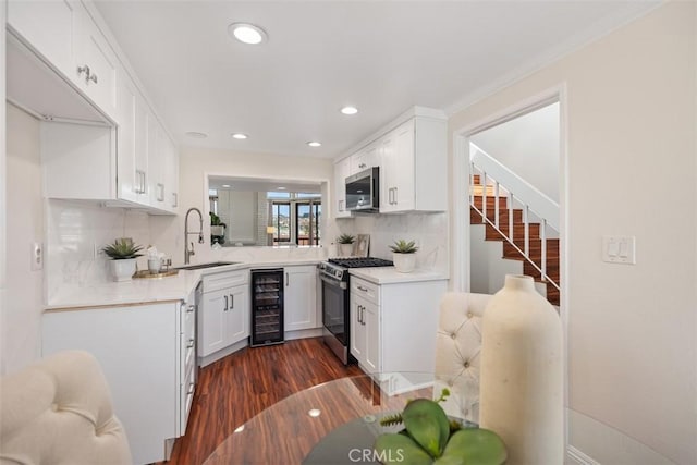27869 Mazagon Unit 111, Mission Viejo, CA 92692 - kitchen featuring appliances with stainless steel finishes, a sink, beverage cooler, dark wood-style floors, and tasteful backsplash