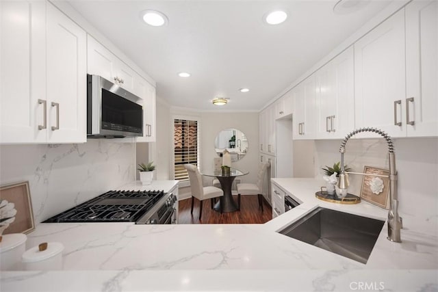 27869 Mazagon Unit 111, Mission Viejo, CA 92692 - kitchen featuring stainless steel appliances, a sink, light stone countertops, white cabinetry, and recessed lighting
