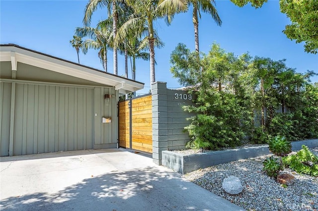 view of home's exterior with fence and board and batten siding