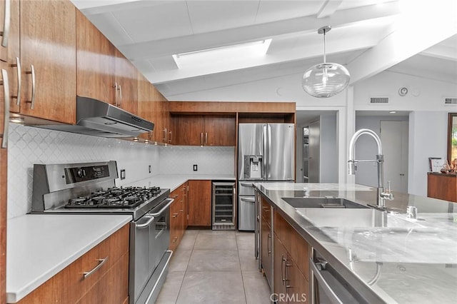 kitchen featuring vaulted ceiling with beams, stainless steel appliances, a sink, visible vents, and wine cooler