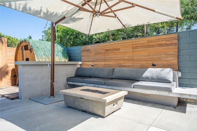 view of patio / terrace with fence and an outdoor fire pit