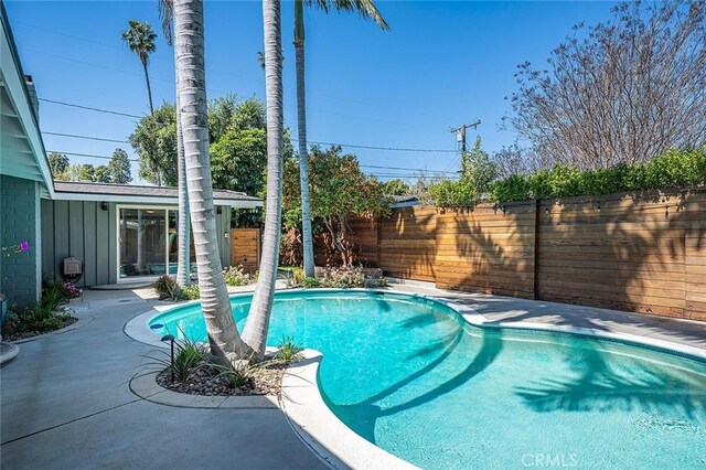 view of swimming pool with a fenced in pool, a patio area, and a fenced backyard