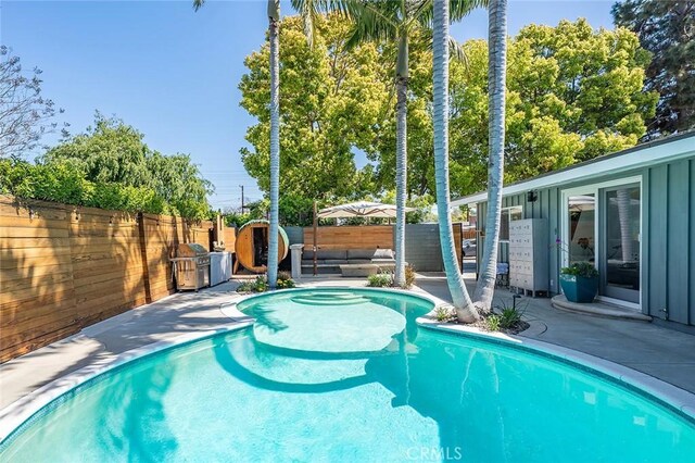 view of swimming pool featuring a fenced in pool, a patio area, and a fenced backyard