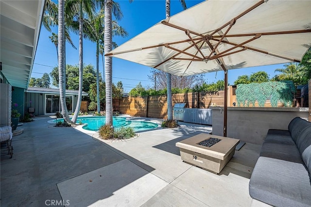 view of patio / terrace featuring a fire pit, a fenced backyard, and a fenced in pool