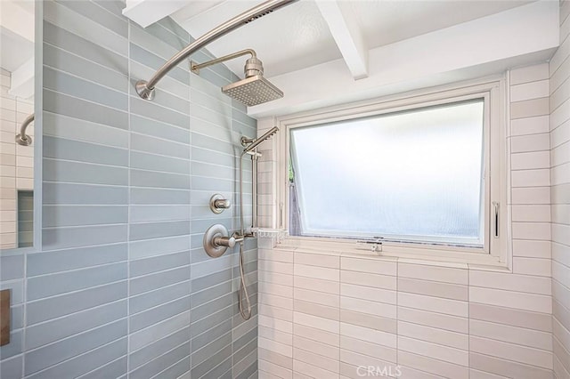 full bathroom with beam ceiling and a tile shower