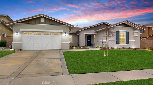 ranch-style home featuring driveway, stucco siding, a garage, and a front yard