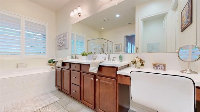 bathroom with a stall shower, visible vents, a sink, and a garden tub