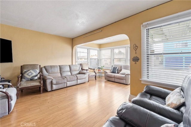 27 E Platt St, Long Beach, CA 90805 - living room with light wood-type flooring and arched walkways