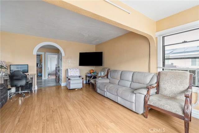 27 E Platt St, Long Beach, CA 90805 - living area featuring arched walkways, wood finished floors, an office area, and baseboards