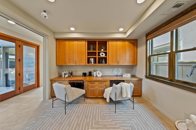 kitchen with visible vents, recessed lighting, built in study area, and light countertops
