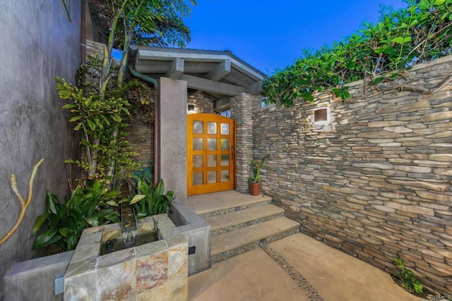 property entrance featuring stone siding