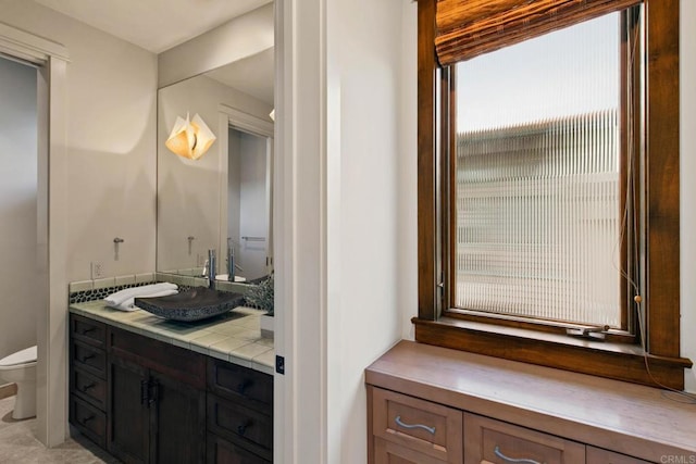 bathroom featuring toilet and vanity