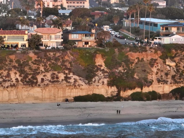 bird's eye view with a water view and a view of the beach