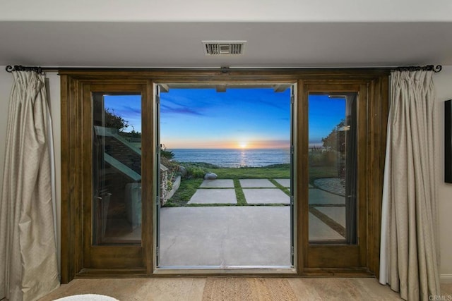 doorway with a water view and visible vents