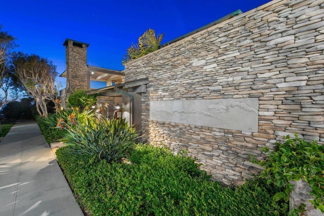 view of side of property featuring stone siding