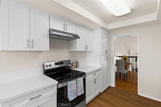 6279 Lincoln Ave, Buena Park, CA 90620 - kitchen featuring electric stove, under cabinet range hood, dark wood-type flooring, and white cabinetry