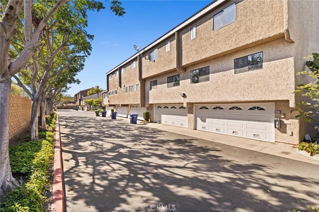 6279 Lincoln Ave, Buena Park, CA 90620 - back of property with an attached garage, stucco siding, and a residential view