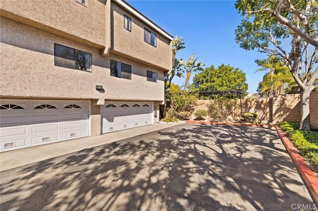 6279 Lincoln Ave, Buena Park, CA 90620 - view of side of property featuring stucco siding, driveway, and a garage