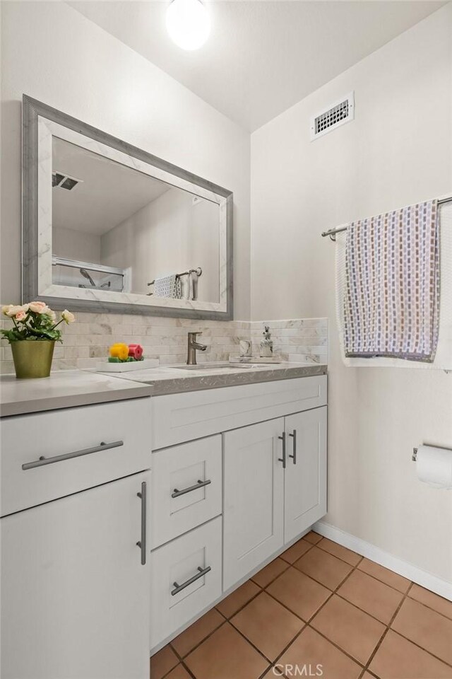 6279 Lincoln Ave, Buena Park, CA 90620 - bathroom featuring vanity, tile patterned floors, and decorative backsplash