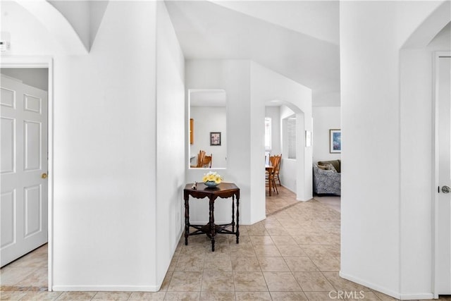 5775 Myrtle Beach Dr, Banning, CA 92220 - hall featuring arched walkways, baseboards, and light tile patterned floors
