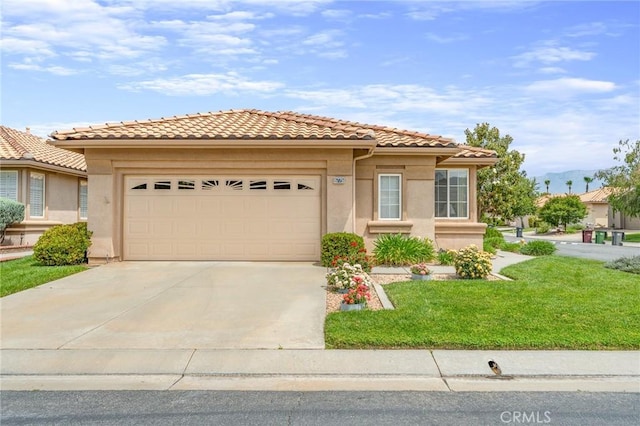 5775 Myrtle Beach Dr, Banning, CA 92220 - mediterranean / spanish-style home with a garage, driveway, stucco siding, a front lawn, and a tile roof