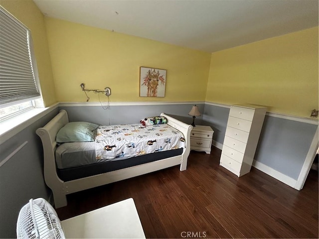 bedroom featuring baseboards and wood finished floors