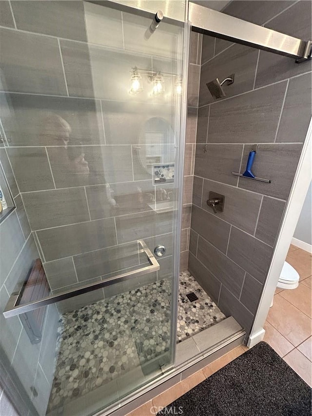 bathroom with tile patterned floors and a stall shower