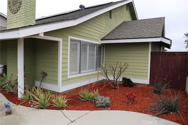 18137 Galatina St, Rowland Heights, CA 91748 - view of home's exterior with a shingled roof, a chimney, and roof mounted solar panels