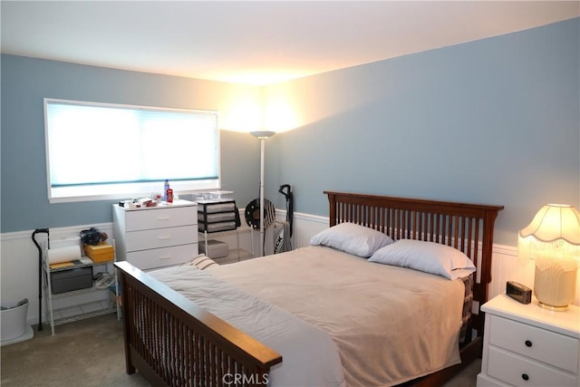carpeted bedroom with wainscoting