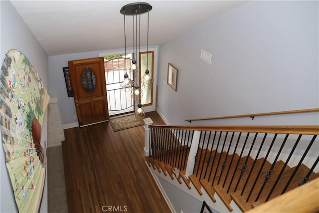 entrance foyer featuring baseboards, vaulted ceiling, and dark wood-style floors
