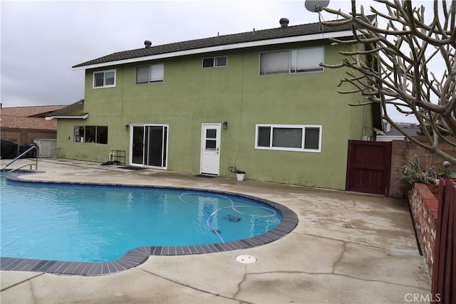 view of pool featuring fence, a fenced in pool, a gate, and a patio
