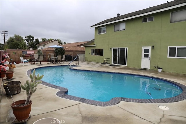 view of swimming pool with a patio area, a fenced backyard, and a fenced in pool