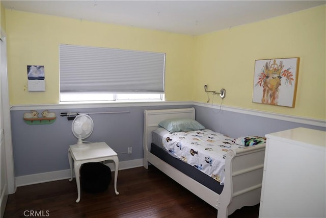 bedroom featuring wood finished floors and baseboards