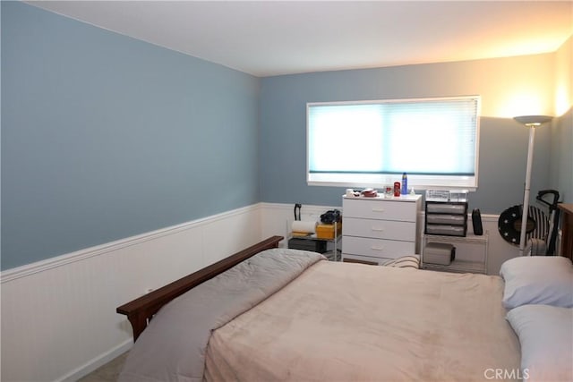 bedroom featuring wainscoting
