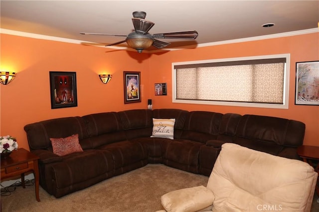 living room featuring a ceiling fan, crown molding, and carpet