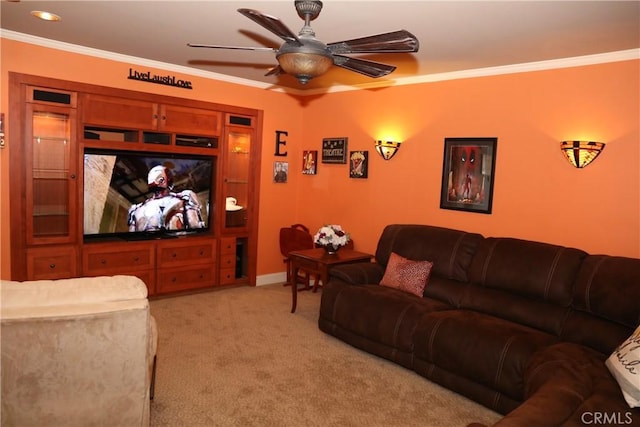 home theater room with light carpet, crown molding, and ceiling fan