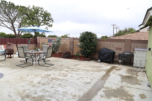 view of patio / terrace with fence, grilling area, and outdoor dining space