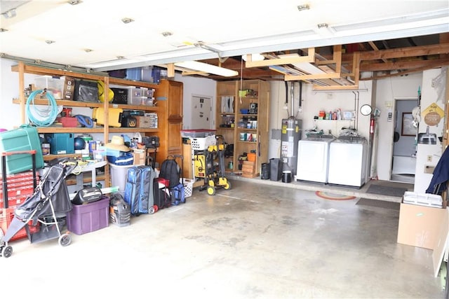garage with washing machine and dryer and water heater