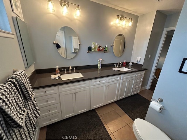 bathroom with tile patterned flooring, a sink, double vanity, and toilet