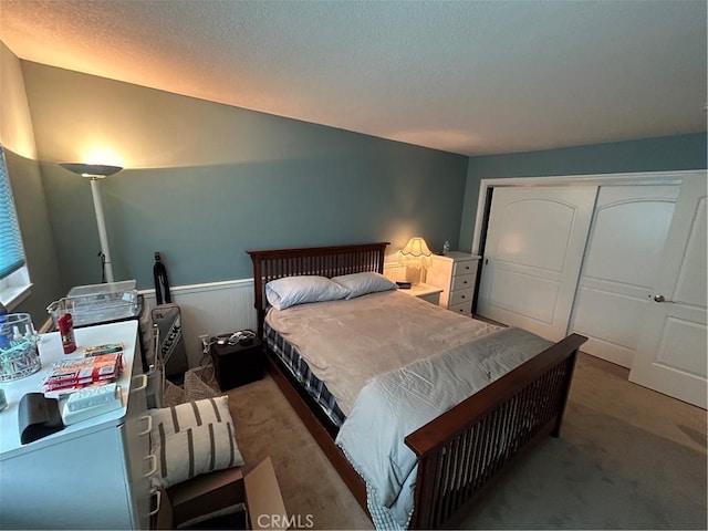 bedroom featuring lofted ceiling, a closet, and carpet flooring