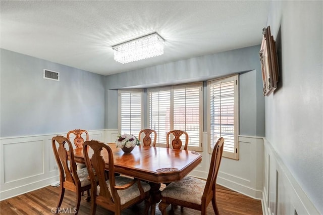 18137 Galatina St, Rowland Heights, CA 91748 - dining area with wainscoting, wood finished floors, a decorative wall, and a textured ceiling