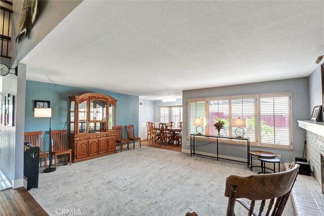 18137 Galatina St, Rowland Heights, CA 91748 - sitting room with a fireplace, a textured ceiling, and carpet flooring