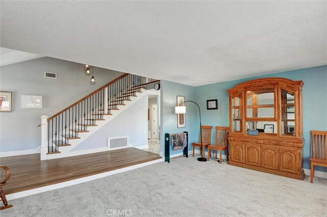 18137 Galatina St, Rowland Heights, CA 91748 - carpeted living area with stairs and a textured ceiling