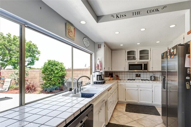 18137 Galatina St, Rowland Heights, CA 91748 - kitchen featuring appliances with stainless steel finishes, tile countertops, light tile patterned floors, tasteful backsplash, and recessed lighting
