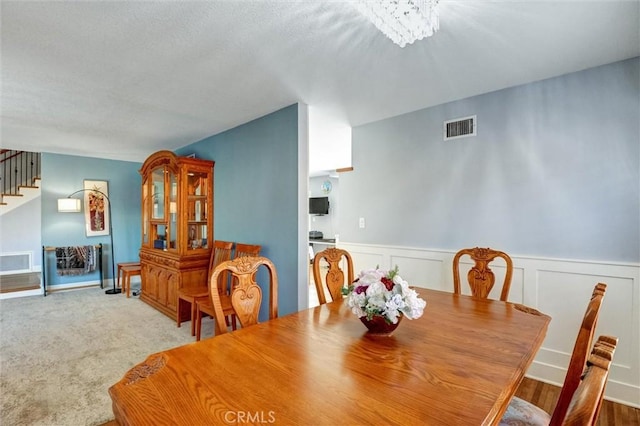 18137 Galatina St, Rowland Heights, CA 91748 - dining space featuring stairs, a wainscoted wall, and a chandelier