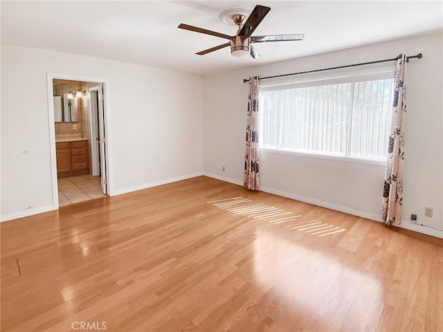 13827 Olathe Rd, Apple Valley, CA 92307 - spare room with a ceiling fan, light wood finished floors, and baseboards
