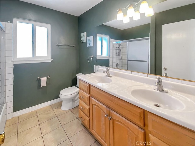 13827 Olathe Rd, Apple Valley, CA 92307 - bathroom with a shower with shower door, tile patterned flooring, toilet, double vanity, and baseboards