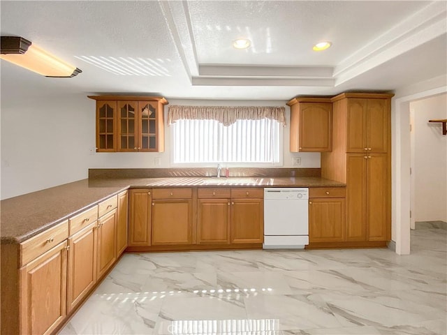 13827 Olathe Rd, Apple Valley, CA 92307 - kitchen featuring dishwasher, glass insert cabinets, a sink, light marble finish floors, and a tray ceiling