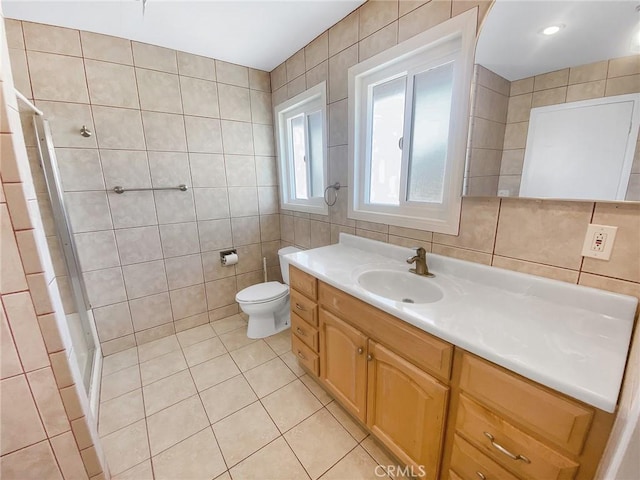 13827 Olathe Rd, Apple Valley, CA 92307 - bathroom featuring tile walls, tile patterned floors, a stall shower, vanity, and toilet